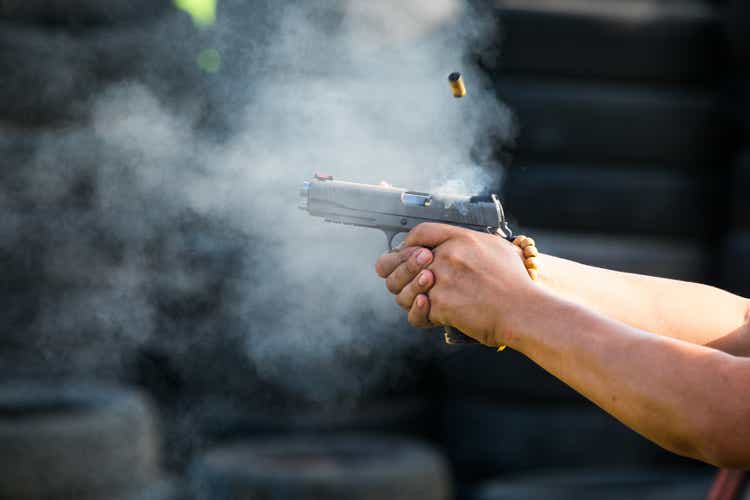 Shooting from a pistol. Reloading the gun. The man is aiming at the target