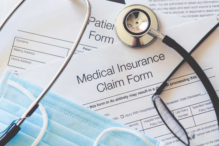 Medical Insurance claim form with stethoscope and surgical face mask.