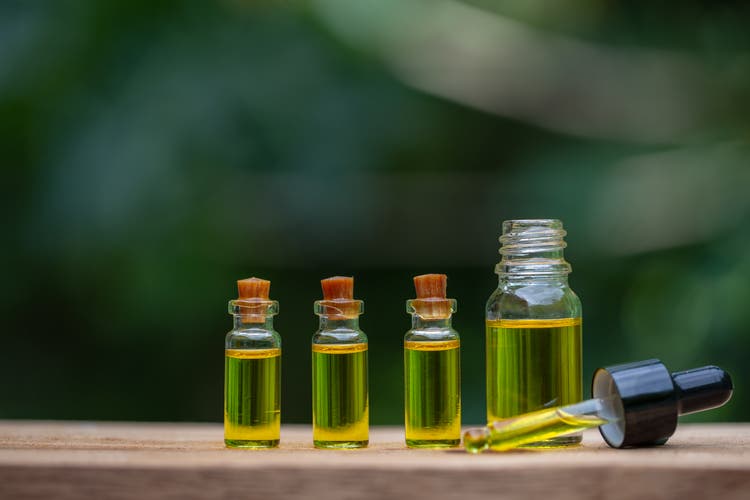 Glass bottles containing hemp oil, drugs extracted CBD Cannabis Oil of researchers or medical team. Herbal alternative medicine.