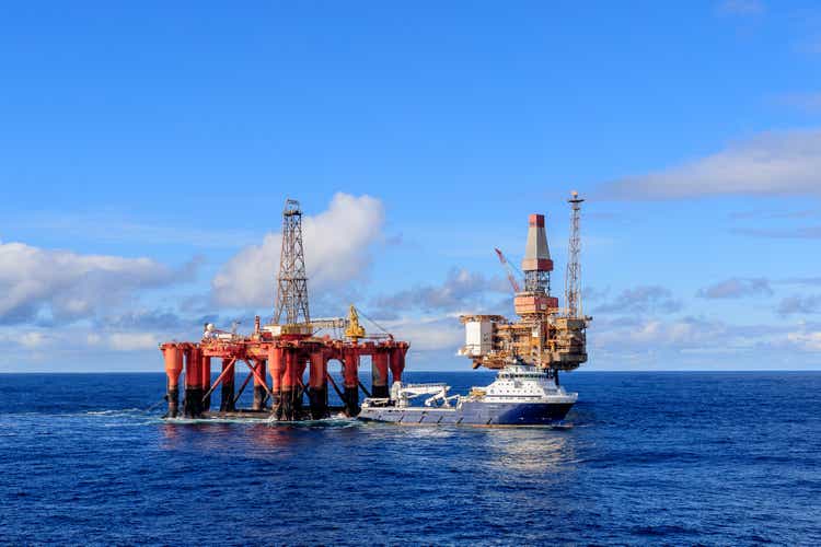 AHTS vessel Island Valiant doing rig move operation for semi submersible rig Borgsten Dolphin next to Dunbar platform.