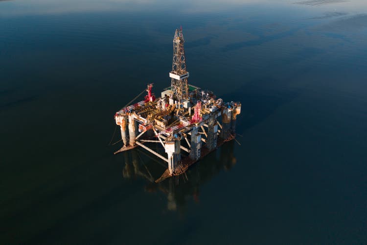 Oil exploration platform in a sea channel photographed by drone, Cromarty Firth, Scotland, United Kingdom
