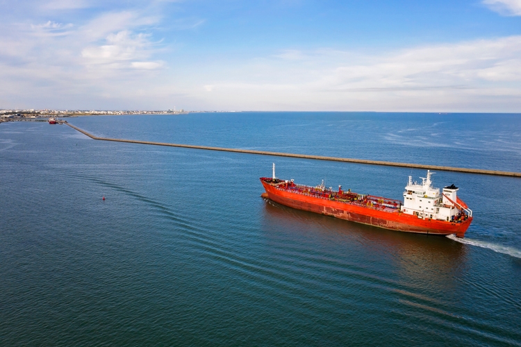 Aerial view of tanker ship carrying oil or gas at sea.