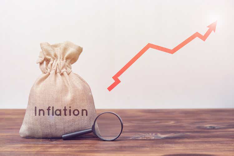 Inflation concept. Bag with a magnifying glass and an up arrow.