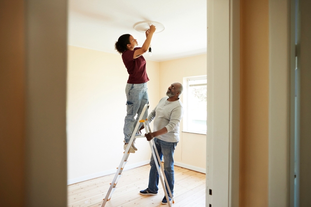 Woman renovating home with father