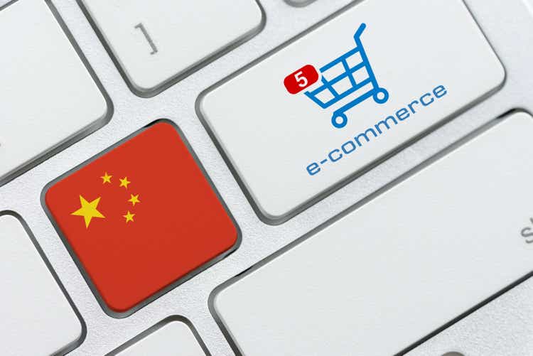 Flag of China, shopping cart with a word e-commerce on a computer keyboard