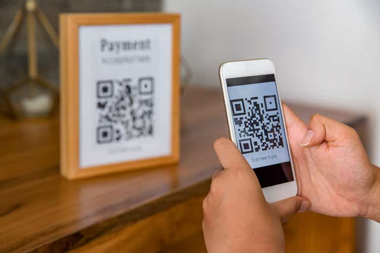 Asian Business woman using QR code mobile payment app