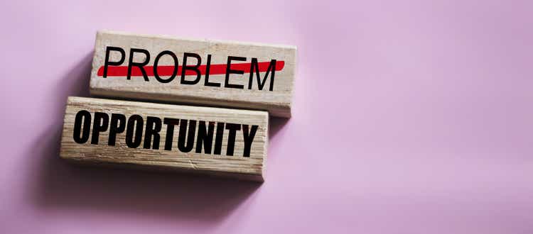 Problem crossed out and opportunity on wooden blocks. Business startup concept