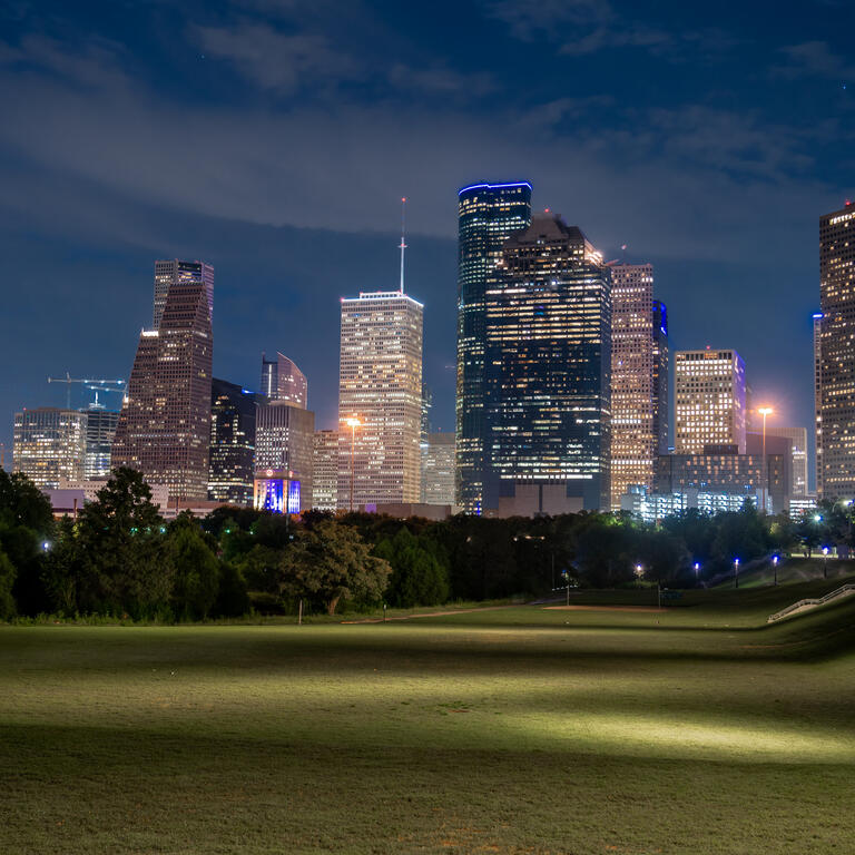 Low Angle View of Wide Open Field With the City of Houston Texas Skyline in the background