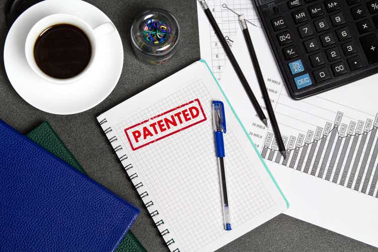 Patented, text in a Notepad on the businessman"s Desk. The concept of the patent
