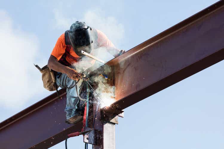 Hispanic ironworker welding a steel girder