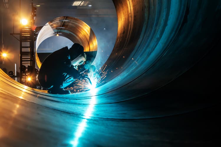 The welder is welding steel plates