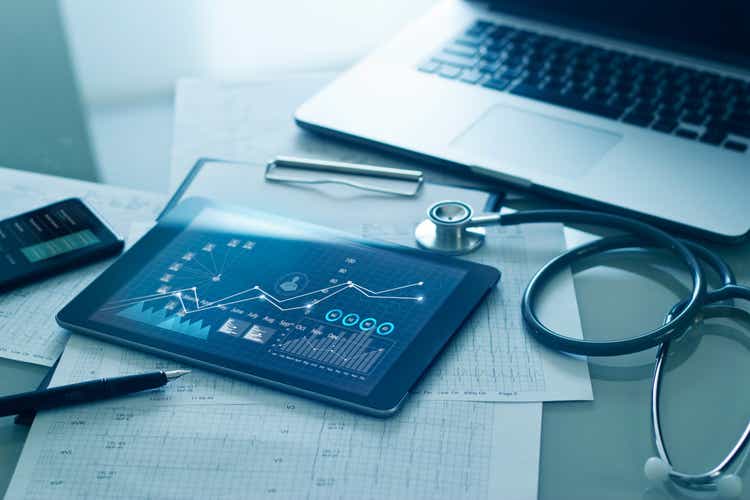 Healthcare business concept, Medical examination and growth graph data of business on tablet with doctor"s health report clipboard on background.