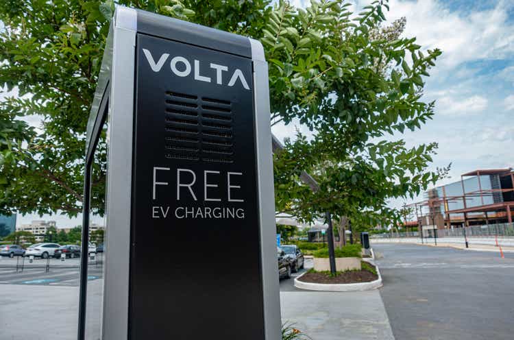 Volta Free EV charging station in parking lot. Power to the electric vehicle concept.