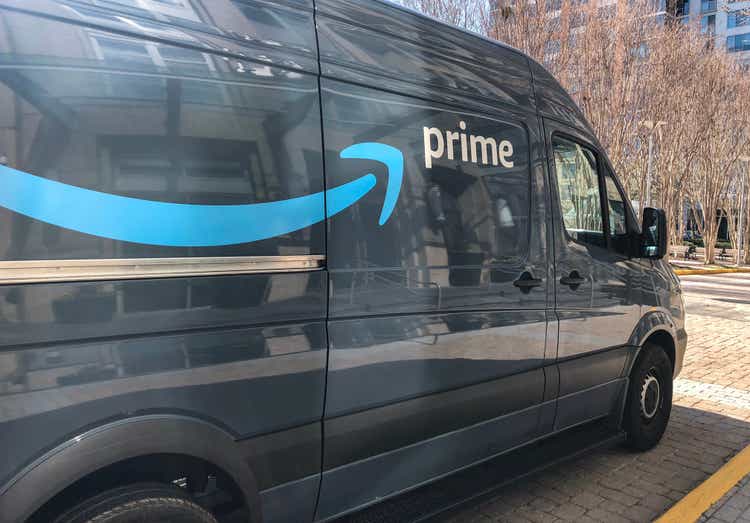 Amazon prime delivery track parked next to entry of Condominium.