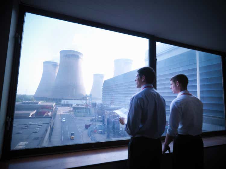 Workers looking out over power station