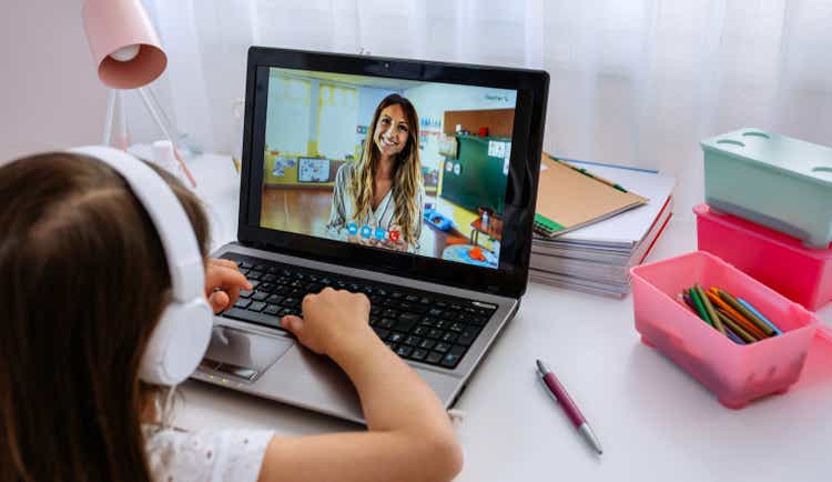 Laptop with teacher teaching class via videoconference