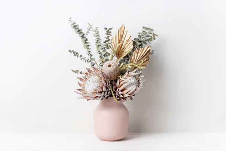 Bohemian dried flower arrangement in a stylish pink vase.
