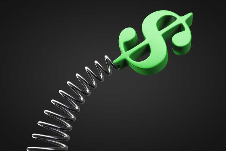 Fluctuating dollar value concept. The dollar symbol on the spring is swinging
