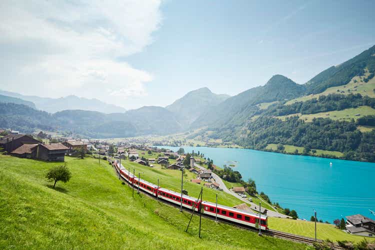 Lush Swiss landscape with commuter train and lake, Lungern, Obwalden, Switzerland