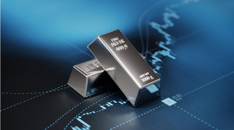 Silver Bars Sitting on Blue Bar Graph - Stock Market and Finance Concept