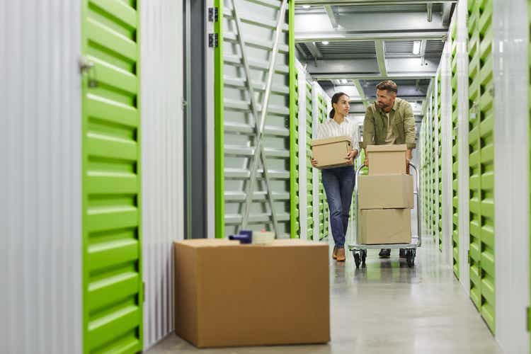 Couple Moving Boxes in Storage Unit