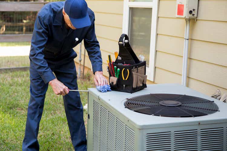 Technician services outside AC units and generator.