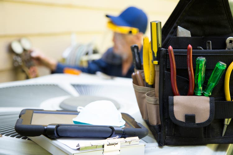 Technician services outside AC units and generator.