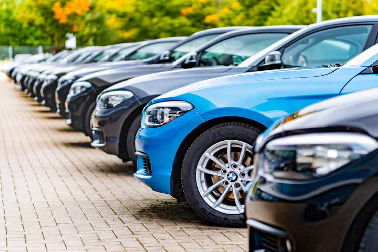 A row of used BMW cars parked at a public car dealership in Hamburg, Germany