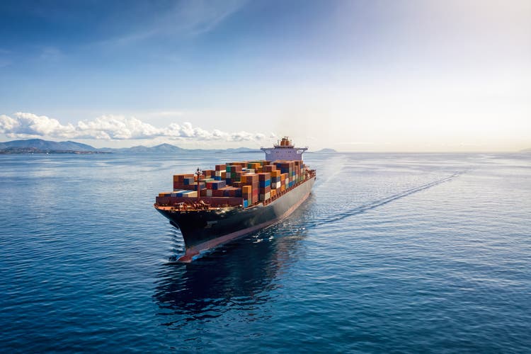 Aerial view of a heavy loaded container cargo vessel