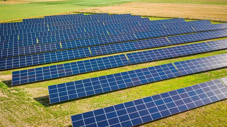 Aerial view of solar panels on green field in Poland