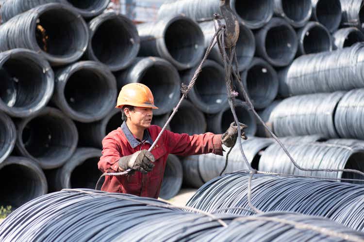 Worker moving steel in the steel market