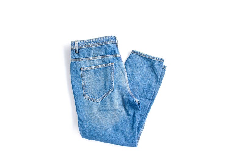 folded blue jeans on a white background. modern casual clothing. flat lay, copy space