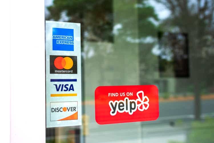 MasterCard, VISA, American Express, Discover payment options on a restaurant door