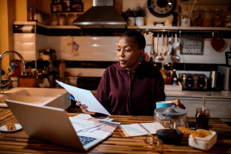Young woman doing home finances in the evening