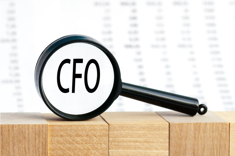 Look closely and CFO with a magnifying glass , business concept image with soft focus background