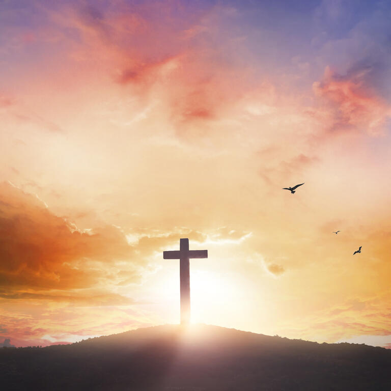 Good Friday concept: Silhouette cross on mountain sunset background