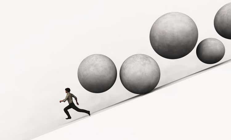 Businessman running away from falling rolling stones . This is a 3d render illustration .