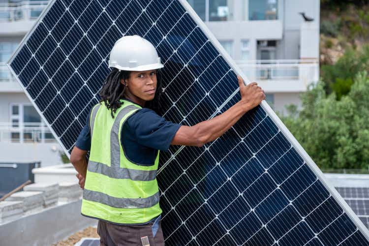 African man installing solar panels