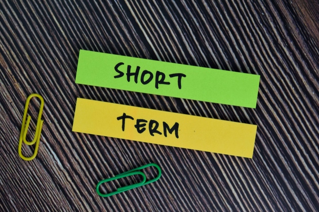Short Term text on sticky notes isolated on office desk