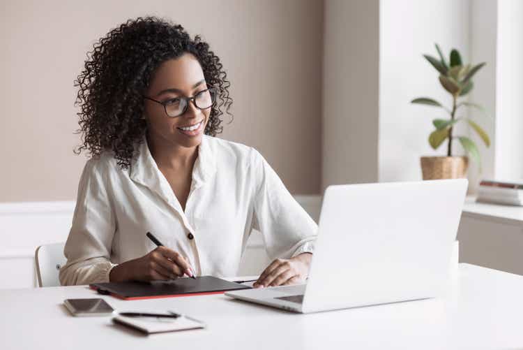 Woman working from home. Student girl using laptop in her room