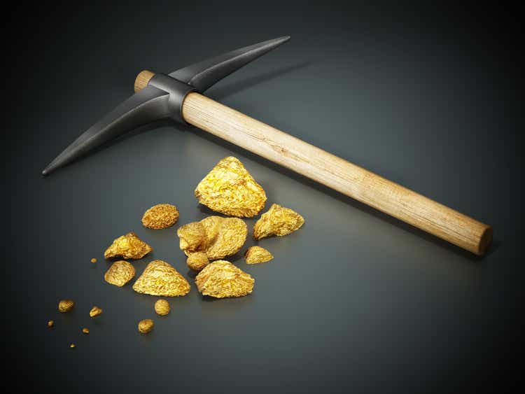 Mining pickaxe and gold nuggets standing on black background