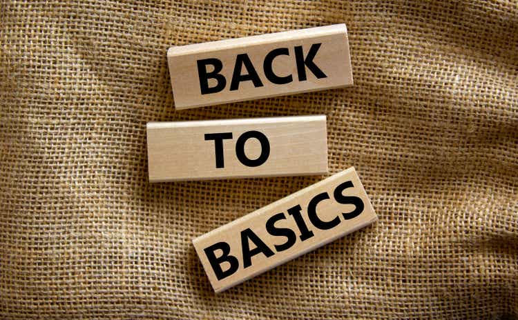 Wooden blocks form the words "back to basics" on canvas background. Business and educational concept.