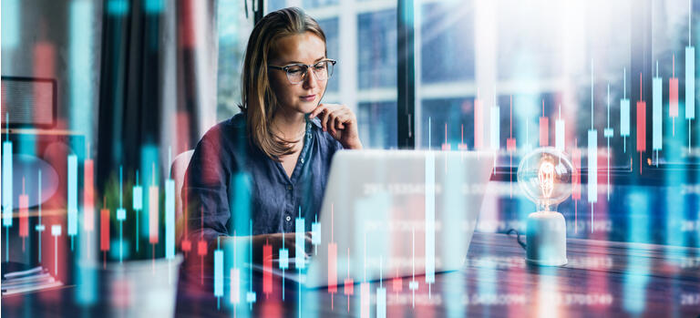Businesswoman working at modern office.Technical price graph and indicator, red and green candlestick chart and stock trading computer screen background. Double exposure. Trader analyzing data