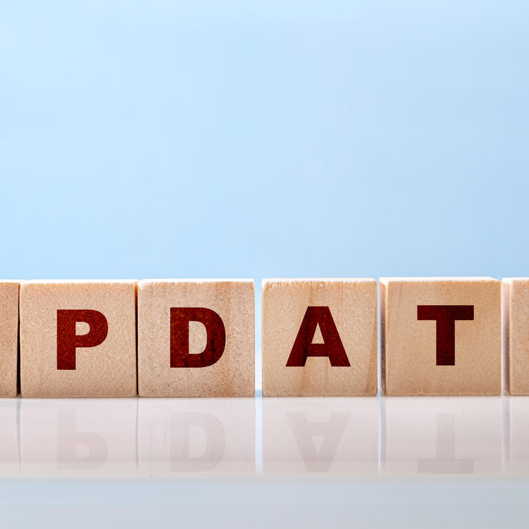 The word Update is written on wooden blocks on a glossy desktop surface on a blue background