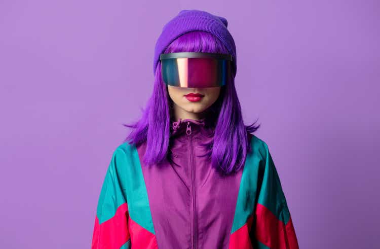 Style woman in VR glasses and 80s tracksuit on violet background