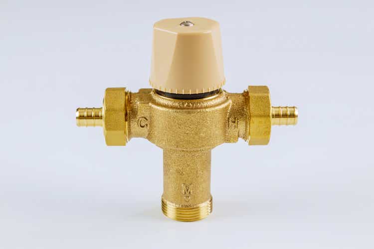 Water various supply plumbing brass thermostatic mixing valve isolated on white background.