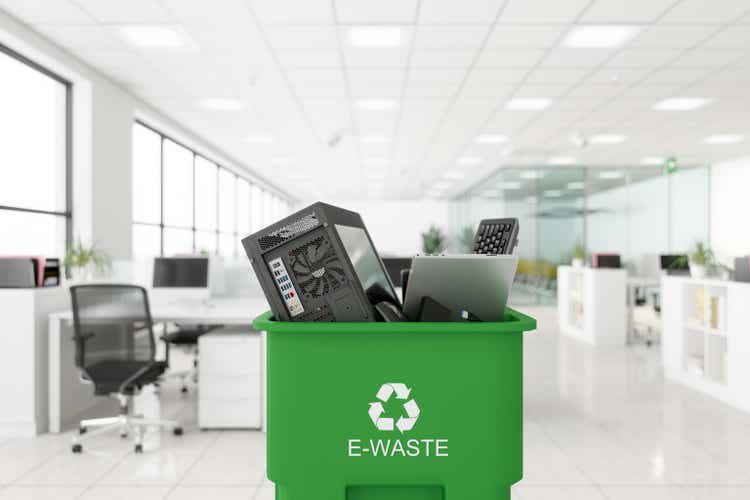 Electronic Wastes Collected In The Green Colored Garbage Bin With E-waste Symbol On It In The Office