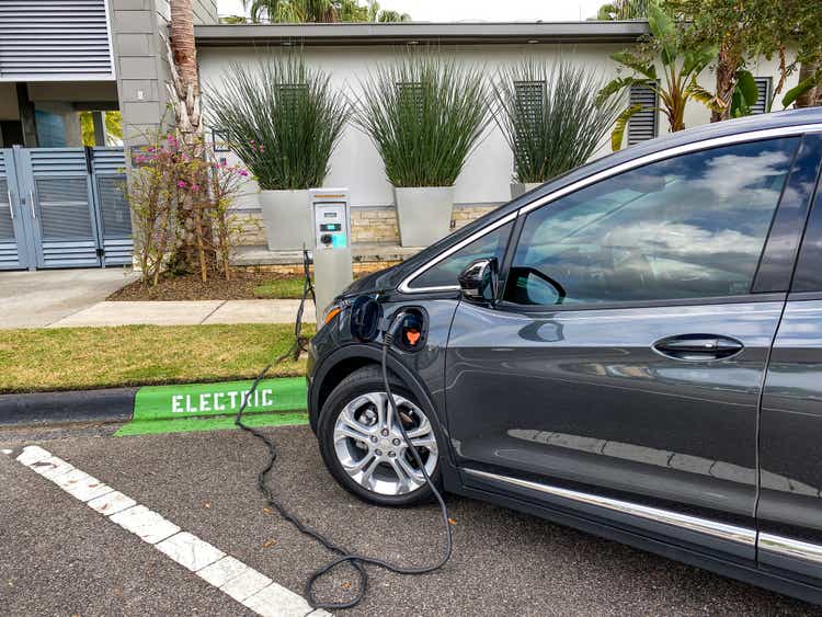 A Chevy Bolt electric vehicle charging at a free public charging station.