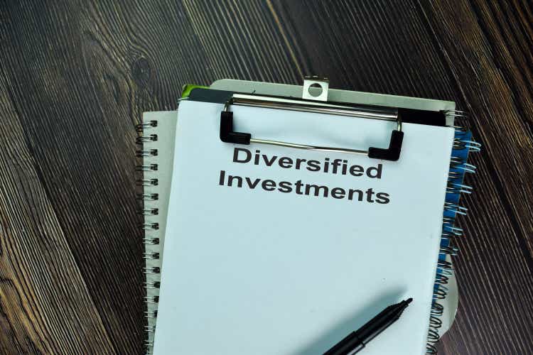 Diversified Investments write on a paperwork isolated on wooden table.