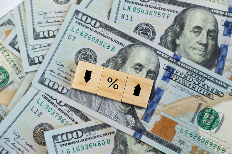 Arrow and percentage sign blocks shows the rise and fall of one hundred american dollar bills